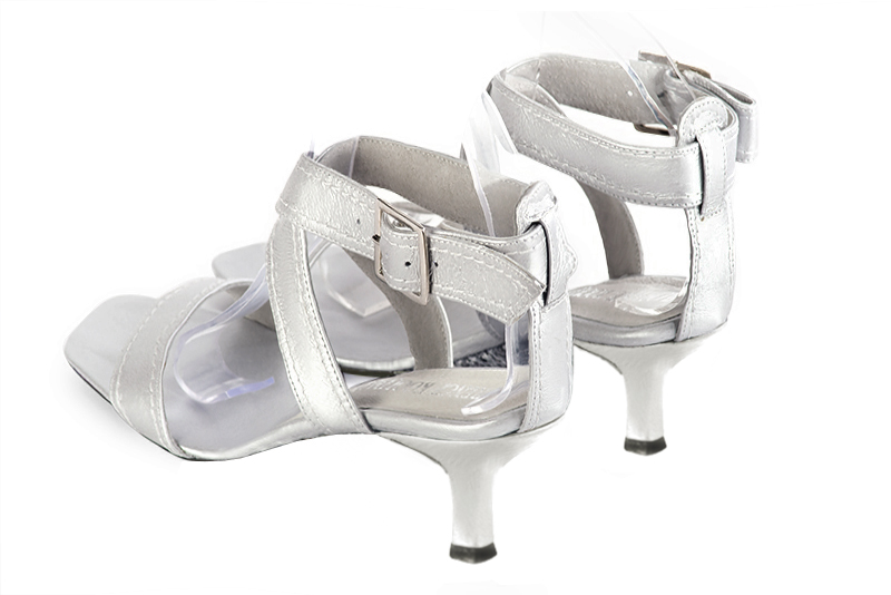 Light silver women's fully open sandals, with crossed straps. Square toe. Medium spool heels. Rear view - Florence KOOIJMAN